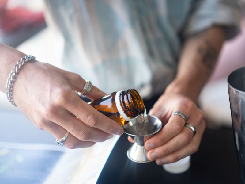 man making cocktails at home